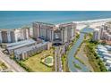 Aerial view of the Resort featuring ocean, river, parking, and surrounding landscaping at 100 North Beach Blvd. # 515, North Myrtle Beach, SC 29582