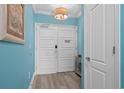 Entryway features light blue walls, plank flooring, white double doors and a foyer table at 100 North Beach Blvd. # 515, North Myrtle Beach, SC 29582