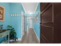 Hallway features light blue walls, plank flooring, white trim, and a dark wood door at 100 North Beach Blvd. # 515, North Myrtle Beach, SC 29582