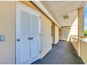 Condo hallway with neutral walls, carpeted floors, and white doors leading to individual units at 101 Ocean Creek Ocean Creek Dr. # Qq3, Myrtle Beach, SC 29572