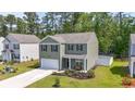 Charming two-story home with an attached two-car garage, manicured lawn, and a fenced-in backyard at 1020 Sennema Circle, Myrtle Beach, SC 29588