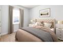 Bright bedroom with a tufted headboard, neutral tones, a side table, and a window at 1034 Laconic Dr., Myrtle Beach, SC 29588