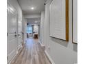 Inviting hallway with wood-look floors that opens to a living space, featuring recessed lighting and stylish wall art at 1035 Laconic Dr., Myrtle Beach, SC 29588