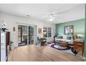 Bright living room with wood-look floors, ceiling fan, and sliding glass doors to a screened-in porch at 1058 Sea Mountain Hwy. # 9-101, North Myrtle Beach, SC 29582