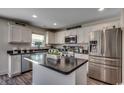 Bright kitchen featuring stainless appliances, granite countertops, white cabinetry and central island at 113 Adelphia Rd., Loris, SC 29569