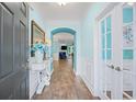Inviting entryway with hardwood floors, white wainscoting, and an arched doorway at 1290 Prescott Circle, Myrtle Beach, SC 29577