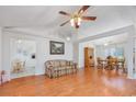 Open-concept living area featuring wood floors, a ceiling fan, and seamless flow into the dining room at 1527 Hallborough Dr., Surfside Beach, SC 29575