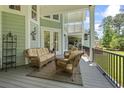 Inviting back porch with comfortable wicker furniture and a decorative heron at 160 Stonington Dr., Murrells Inlet, SC 29576
