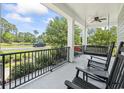 Relaxing front porch with rocking chairs and a swing, offering a peaceful outdoor space at 160 Stonington Dr., Murrells Inlet, SC 29576