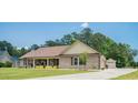Traditional brick home offers a well-kept lawn and a charming covered porch, perfect for enjoying the outdoors at 193 Field Loop Rd., Georgetown, SC 29440