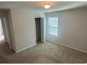 Cozy bedroom with neutral carpet, a window with blinds, and a closet, ideal for relaxation and storage at 198 Foxford Dr., Conway, SC 29526
