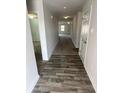 Inviting hallway with wood-look flooring that transitions to plush carpet, leading to various rooms within the home at 198 Foxford Dr., Conway, SC 29526
