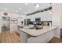 Bright kitchen with granite counters, a stainless steel refrigerator, and modern appliances at 2000-D Willow Run Dr. # D, Little River, SC 29566