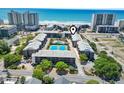 Aerial view of a beachside condo complex with pool and tennis courts at 206 2Nd Ave. N # 271, North Myrtle Beach, SC 29582