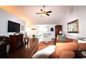 Spacious living room with hardwood floors, a ceiling fan, and a cozy fireplace for relaxing evenings at 233 Oak Lea Dr., Conway, SC 29526