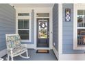 Welcoming front porch with a decorative wreath on the door and a comfortable rocking chair at 2492 Goldfinch Dr., Myrtle Beach, SC 29577