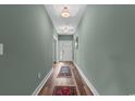 Inviting entryway featuring wood floors, decorative rugs, and neutral wall colors at 2505 Suzanne Dr., Conway, SC 29526