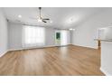 Bright, spacious living room with stylish hard flooring, ceiling fan and natural light with easy access to outdoors at 255 Yauhanna Lake Dr., Georgetown, SC 29440