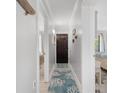 Inviting hallway with gray walls, hardwood floors, and beach-themed decor leading to multiple rooms at 307 74Th Ave. N # 3C, Myrtle Beach, SC 29572