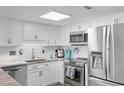 Well-lit kitchen featuring stainless steel appliances, white cabinets, and a stylish countertop at 307 74Th Ave. N # 3C, Myrtle Beach, SC 29572