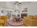 Cozy living room with a fireplace, ceiling fan, and views into the dining area at 3071 Alice Ln., Little River, SC 29566