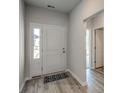 Inviting foyer featuring modern flooring, natural light, and a view into the rest of the home at 319 Garden Grove St, Conway, SC 29526