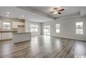 Open-concept living and kitchen area featuring modern flooring, natural light and neutral paint at 319 Garden Grove St, Conway, SC 29526