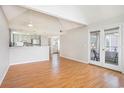 Open living space featuring vaulted ceilings, laminate floors, a kitchen view, and access to a private outdoor balcony at 351 Lake Arrowhead Rd. # 24-396, Myrtle Beach, SC 29572