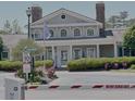 Exterior view of the community clubhouse with lush landscaping and ample parking at 3761 Citation Way # 531, Myrtle Beach, SC 29577