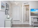 Hallway with a Main Street sign, storage closet, and open view to a half bathroom at 404 1St Ave. N # H, North Myrtle Beach, SC 29582