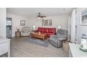 Inviting living room featuring wood flooring, and comfortable seating with half bathroom access at 404 1St Ave. N # H, North Myrtle Beach, SC 29582