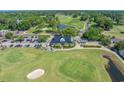 Aerial view of golf course with clubhouse, driving range, and surrounding greenery at 4450 Turtle Ln. # 2-A, Little River, SC 29566