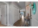 Hallway with white walls, wood floors, and decorated with coastal-themed art at 4450 Turtle Ln. # 2-A, Little River, SC 29566