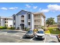 Inviting condominium building with traditional design, outdoor balconies, and well-maintained parking at 4520 Coquina Harbour Dr. # F-3, Little River, SC 29566