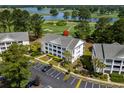 Scenic aerial view of the condo complex nestled on a golf course near a serene lake at 4940 Windsor Green Way # 301, Myrtle Beach, SC 29579