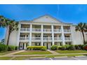 Inviting condo exterior featuring multiple balconies, lush landscaping at 4940 Windsor Green Way # 301, Myrtle Beach, SC 29579