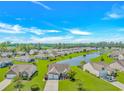 Expansive aerial view of a residential community with a central lake and well-maintained landscaping at 5 Coffee Mill Creek Ln., Carolina Shores, NC 28467