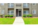 Condo exterior with white railings and lush green lawn at 500 Myrtle Greens Dr. # D, Conway, SC 29526