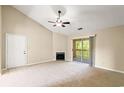 Bright living room with carpet, a fireplace, and sliding door access to a balcony at 500 Myrtle Greens Dr. # D, Conway, SC 29526