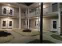 Charming condo exterior at night with cozy lighting, balconies, and manicured landscape at 5406 Sweetwater Blvd. # 5406, Murrells Inlet, SC 29576