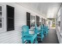Cozy porch with bright turquoise chairs, ideal for outdoor relaxation and enjoying the breeze at 6001-1833 S Kings Hwy., Myrtle Beach, SC 29575