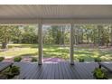 Covered porch overlooking a beautifully landscaped backyard, perfect for outdoor relaxation and entertaining at 62 Warbler St., Georgetown, SC 29440