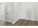 Clean entryway featuring wood-look flooring and white doors leading to various rooms at 622 Castillo Dr., Loris, SC 29569