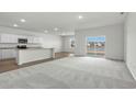 Open-concept kitchen and living room featuring granite countertops, modern appliances and a lake view at 622 Castillo Dr., Loris, SC 29569