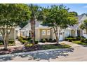 Street view of well-maintained single-story home with landscaping and mature trees at 6244 Catalina Dr. # 511, North Myrtle Beach, SC 29582