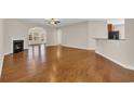 Open-concept living room with a fireplace, hardwood floors, and a view of the outdoor area at 644 Harbor Bay Dr., Murrells Inlet, SC 29576