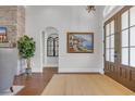 Inviting foyer with hardwood floors, a jute rug, artwork and an arched entry leading to other rooms at 7202 Seville Dr., Myrtle Beach, SC 29572