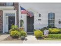 Close-up of the front entrance with black door, American flag, and decorative landscaping at 815 Murray Ave., Myrtle Beach, SC 29577