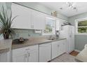 Bright kitchen with white cabinets and appliances at 9679 Stillwater Ct., Myrtle Beach, SC 29572