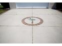 Concrete driveway featuring a South Carolina palmetto tree and crescent moon emblem at 1044 Vestry Dr., Murrells Inlet, SC 29576